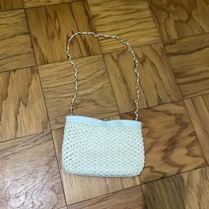 Morris Moskowitz white woven bag with gold and white strap.
